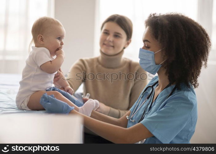 little baby being health clinic vaccination
