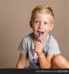 little baby boy with tooth brush,dental hygiene and health for children,brown background.
