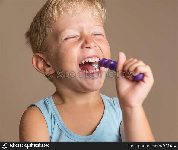 little baby boy with tooth brush,kid boy smiling happiness,dental hygiene and health for children,brown background.