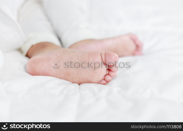 little baby feet on a bed