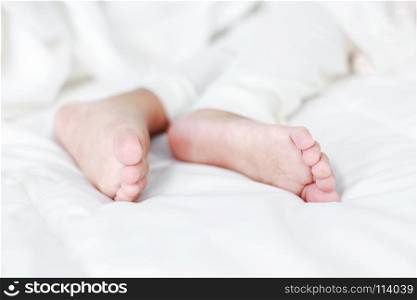 little baby feet on a bed