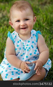 Little baby girl portrait on the green grass