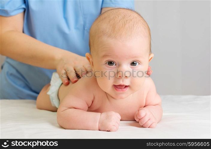 Little baby on table with doctor
