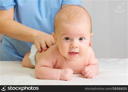 Little baby on table with doctor