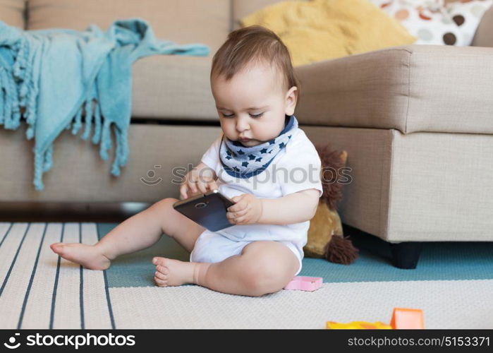 Little baby playing with a smartphone - Technology addiction