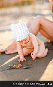 Little baby playing with sand on beach&#xA;