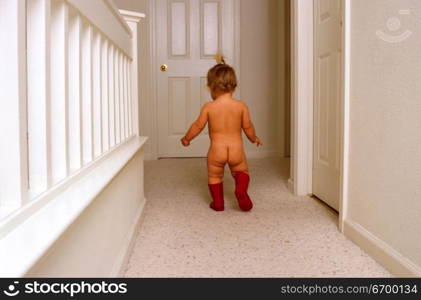 little baby walking nude in corridor