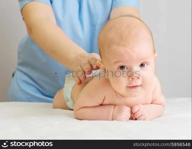 Little baby with doctor on table