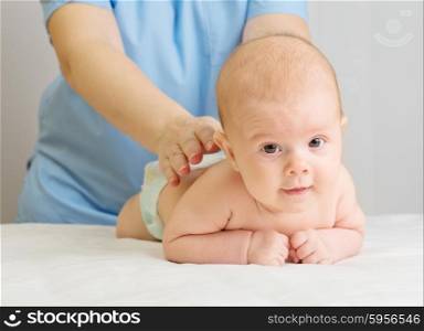 Little baby with doctor on table