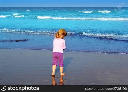 little blond beach girl rear view sea turquoise waves