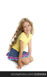 little blond girl smiling portrait on her knees isolated on white background