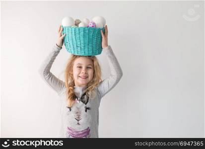 Little blonde girl holding basket with painted eggs. Easter day.. Little blonde girl holding basket with painted eggs. Easter day