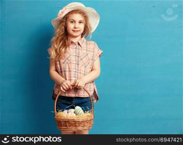 Little blonde girl holding basket with painted eggs. Easter day.. Little blonde girl holding basket with painted eggs. Easter day