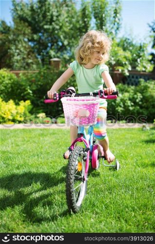 Little blonde girl with her bicycle
