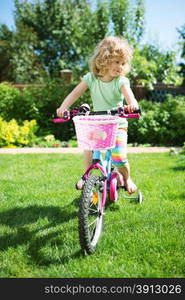 Little blonde girl with her bicycle