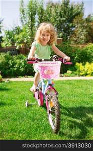 Little blonde girl with her bicycle