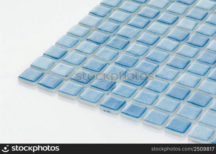 little blue ceramic tile on a white background, majolica. for the catalog. square small tile