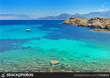 little boat in a beautiful blue and clear sea in island of Corsica