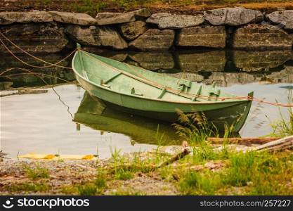 Little boat on water river or lake surface in green nature. Little boat on water surface