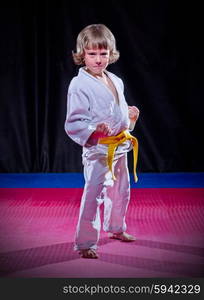 Little boy aikido fighter on black