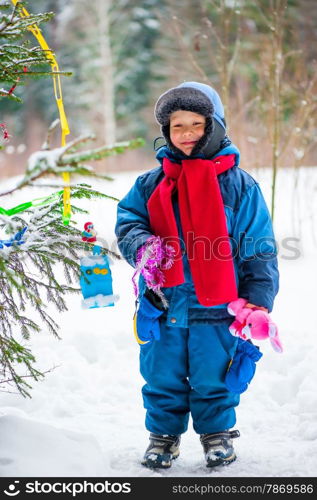 little boy and christmas tree outdoors