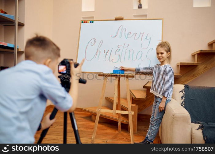 Little boy and girl, bloggers makes christmas blog, little vloggers. Kids blogging in home studio, social media for young audience, online internet broadcast. Little boy and girl, bloggers makes christmas blog