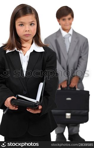 Little boy and girl dressed in business clothing