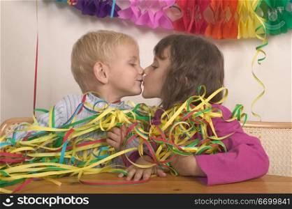Little Boy And Girl Kissing At A Party
