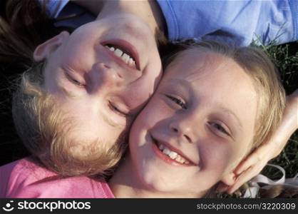 Little Boy and Girl Lying on Grass