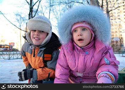 little boy and girl on street in winter 2