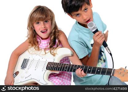 Little boy and girl playing musical instruments