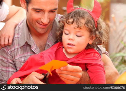 Little boy and his father preparing Halloween party