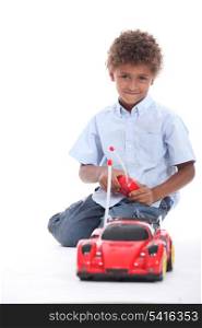 little boy at play with remote-controlled racing car