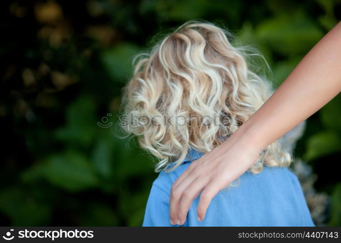 Little boy back in the park by her mother care