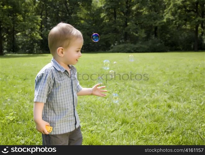 Little Boy Blowing Soap Bubbles