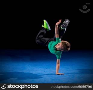 Little boy breakdancer on black