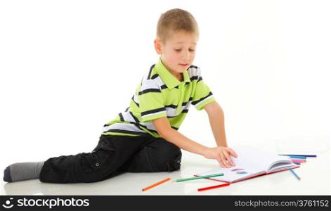 little boy child drawing with color pencils on floor isolated on white background
