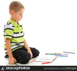 little boy child drawing with color pencils on floor isolated on white background