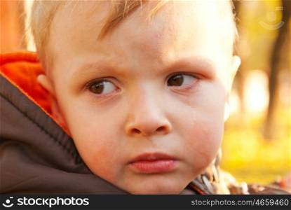 Little boy crying outdoors
