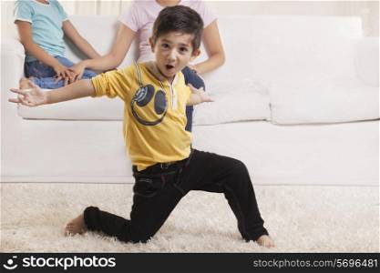 Little boy dancing with family in the background