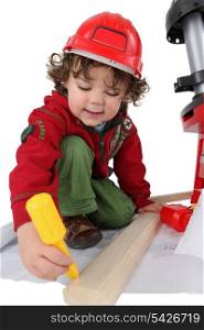 little boy disguised as carpenter