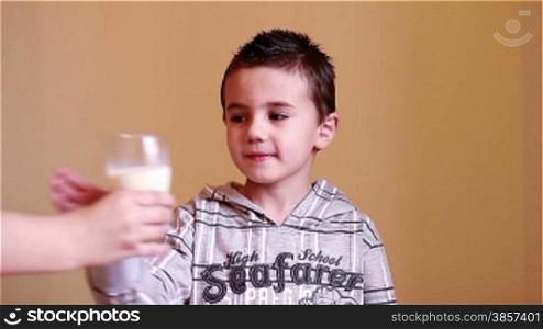 Little boy drinking a glass of milk