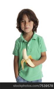 Little boy eating a banana on white background