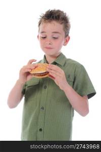 Little boy eating a hamburger. isolated on a white background