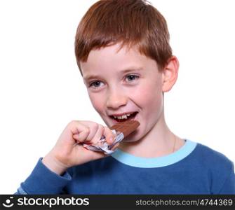 little boy eating chocolate isolated on white