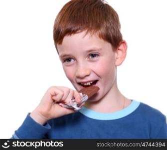 little boy eating chocolate isolated on white