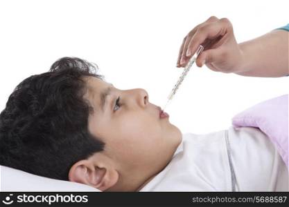 Little boy getting his temperature taken