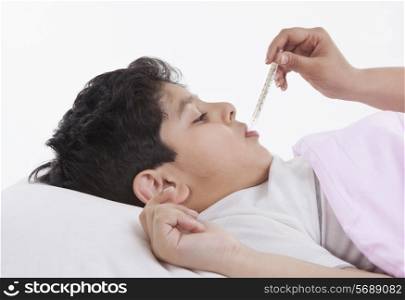 Little boy getting his temperature taken