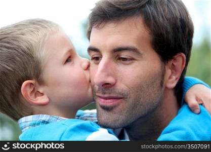 Little boy giving daddy a kiss