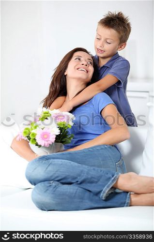 Little boy giving flowers to his mom on mother&acute;s day